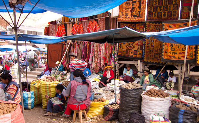 Sacred Valley Pisac Market merchants selling potatoes and textiles